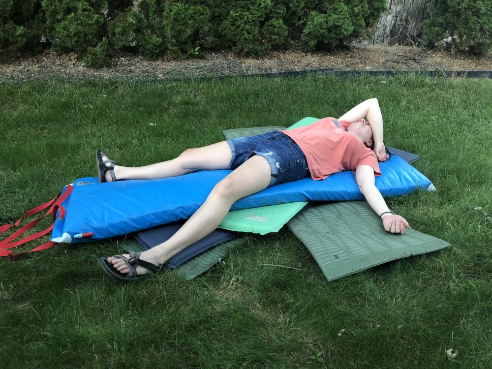 Ali trying to sleep on a stack of 8 camp mattresses