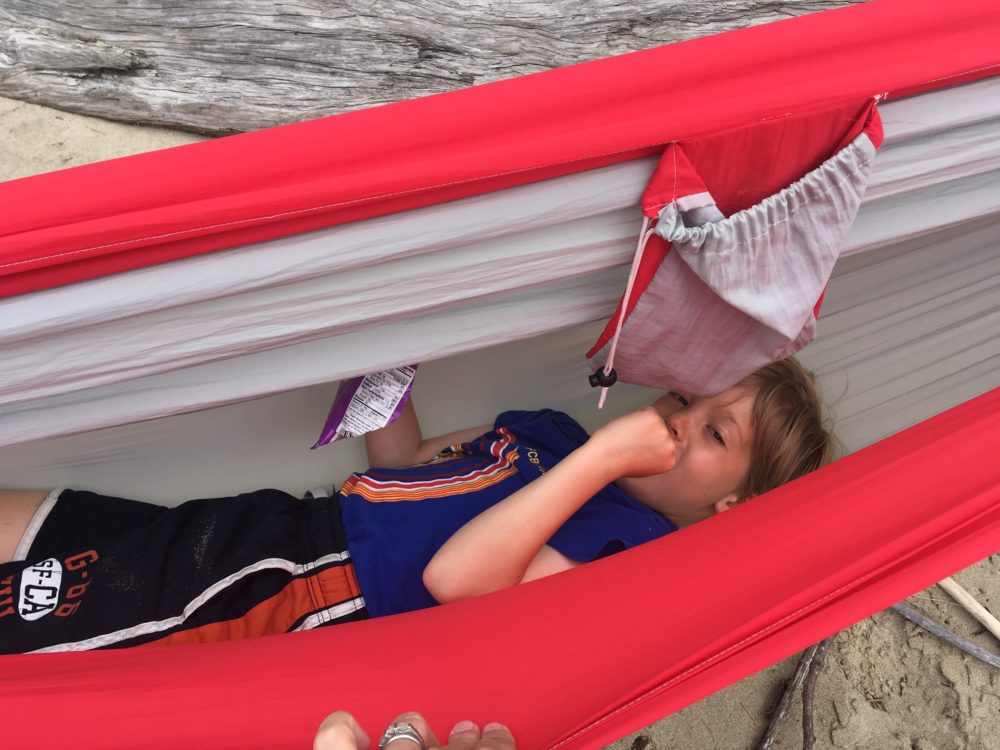 Boy trying to sleep in hammock