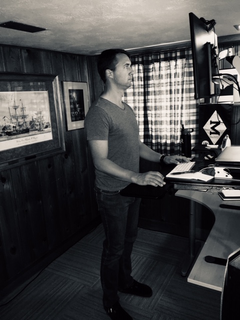 Man with good posture at standing desk.